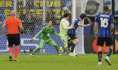 Inter Milan's Francesco Acerbi, second right, scores his side's third goal during the Champions League semifinal second leg soccer match between Inter Milan and Barcelona at San Siro stadium in Milan , Italy, Tuesday, May 6, 2025. (AP Photo/Luca Bruno)
