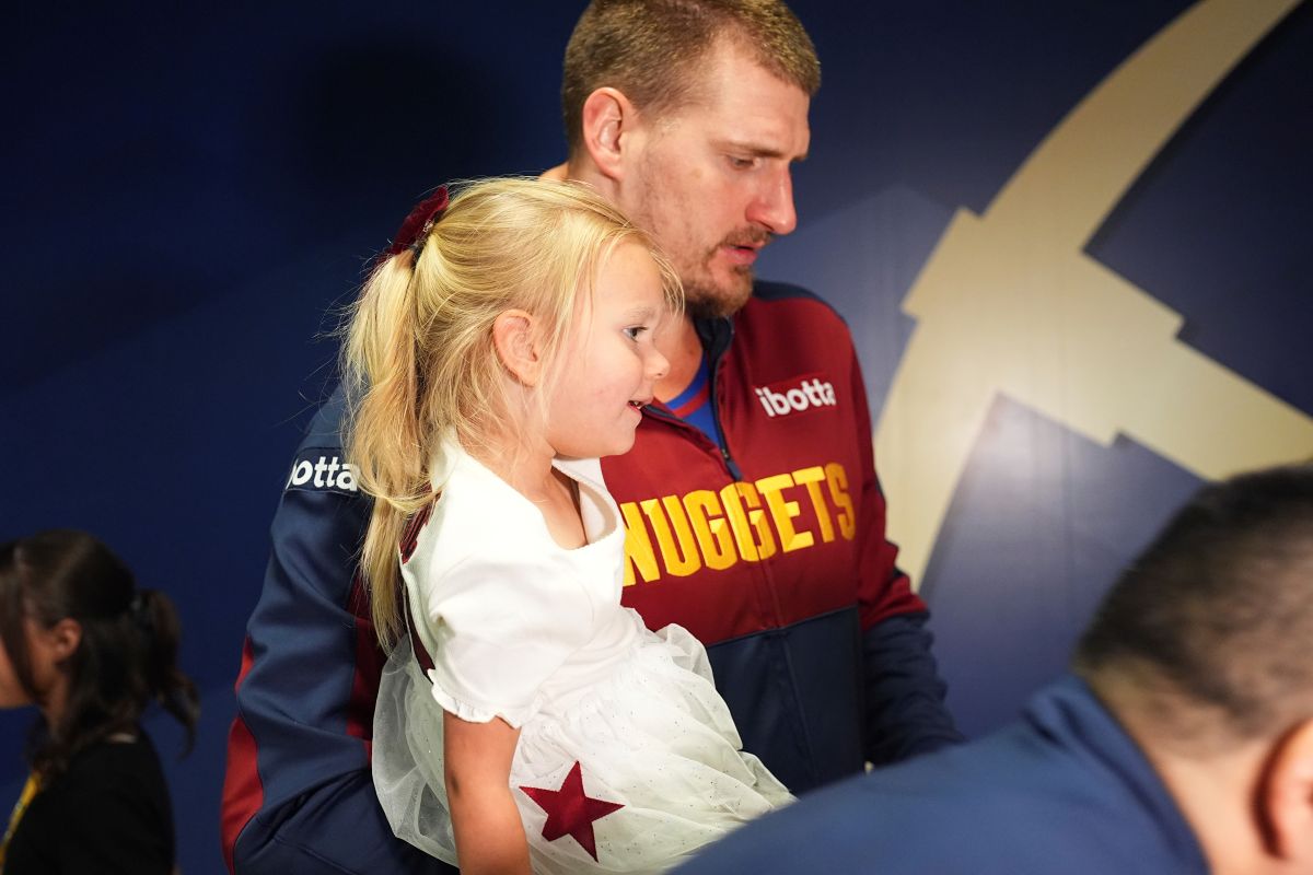 Denver Nuggets center Nikola Jokic holds his daughter after Game 7 of an NBA basketball first-round playoff series against the Los Angeles Clippers, Saturday, May 3, 2025, in Denver. (AP Photo/David Zalubowski)