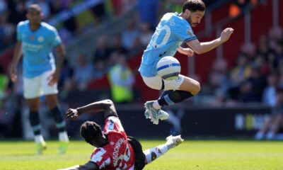 Southampton's Lesley Ugochukwu, bottom left, and Manchester City's Bernardo Silva battle for the ball during their Premier League soccer match at St Mary's Stadium, Southampton, England, Saturday May 10, 2025. (Andrew Matthews/PA via AP)