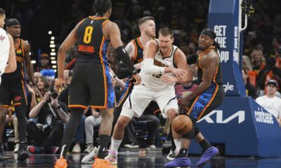 Denver Nuggets center Nikola Jokic, center, loses control of the ball as Oklahoma City Thunder's Jalen Williams (8), Isaiah Hartenstein, center rear, and Luguentz Dort, right, defend in the second half of Game 2 in the conference semifinals of the NBA basketball playoffs, Wednesday, May 7, 2025, in Oklahoma City. (AP Photo/Kyle Phillips)