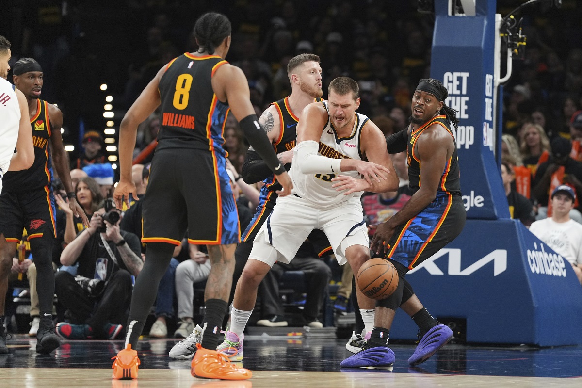 Denver Nuggets center Nikola Jokic, center, loses control of the ball as Oklahoma City Thunder's Jalen Williams (8), Isaiah Hartenstein, center rear, and Luguentz Dort, right, defend in the second half of Game 2 in the conference semifinals of the NBA basketball playoffs, Wednesday, May 7, 2025, in Oklahoma City. (AP Photo/Kyle Phillips)