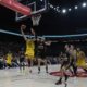 Fenerbahce's Marko Guduric, left, goes for a layup as Monaco's Nick Calathes tries to block him during the Euroleague final basketball match between Monaco and Fenerbahce in Abu Dhabi, United Arab Emirates, Sunday, May 25, 2025. (AP Photo/Altaf Qadri)