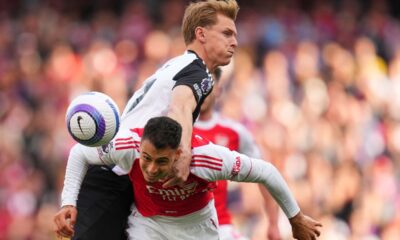 Newcastle's Emil Krafth challenges for the ball with Arsenal's Gabriel Martinelli, bottom, during the English Premier League soccer match between Arsenal and Newcastle United at Emirates stadium in London, Sunday, May 18, 2025. (AP Photo/Kirsty Wigglesworth)