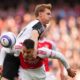 Newcastle's Emil Krafth challenges for the ball with Arsenal's Gabriel Martinelli, bottom, during the English Premier League soccer match between Arsenal and Newcastle United at Emirates stadium in London, Sunday, May 18, 2025. (AP Photo/Kirsty Wigglesworth)