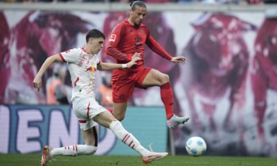 Leipzig's Kosta Nedeljkovic, left, challenges for the ball with Bayern's Leroy Sane during the German Bundesliga soccer match between RB Leipzig and FC Bayern Munich at the Red Bull Arena in Leipzig, Germany, Saturday, May 3, 2025. (AP Photo/Ebrahim Noroozi)