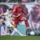 Leipzig's Kosta Nedeljkovic, left, challenges for the ball with Bayern's Leroy Sane during the German Bundesliga soccer match between RB Leipzig and FC Bayern Munich at the Red Bull Arena in Leipzig, Germany, Saturday, May 3, 2025. (AP Photo/Ebrahim Noroozi)