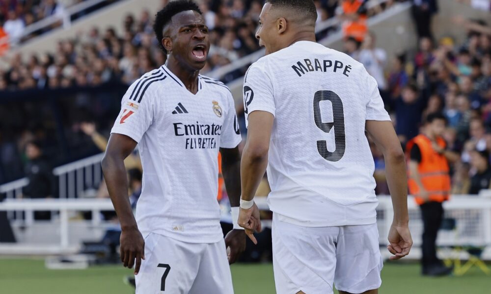 Real Madrid's Vinicius Junior, left, and Kylian Mbappe celebrate after a goal during the La Liga soccer match between Barcelona and Real Madrid in Barcelona, Spain, Sunday, May 11, 2025. AP Photo/Joan Monfort)