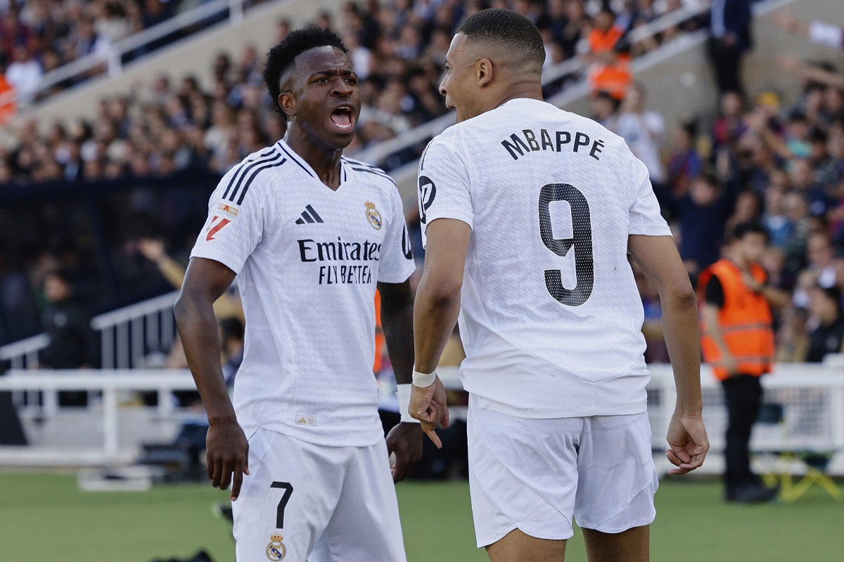 Real Madrid's Vinicius Junior, left, and Kylian Mbappe celebrate after a goal during the La Liga soccer match between Barcelona and Real Madrid in Barcelona, Spain, Sunday, May 11, 2025. AP Photo/Joan Monfort)