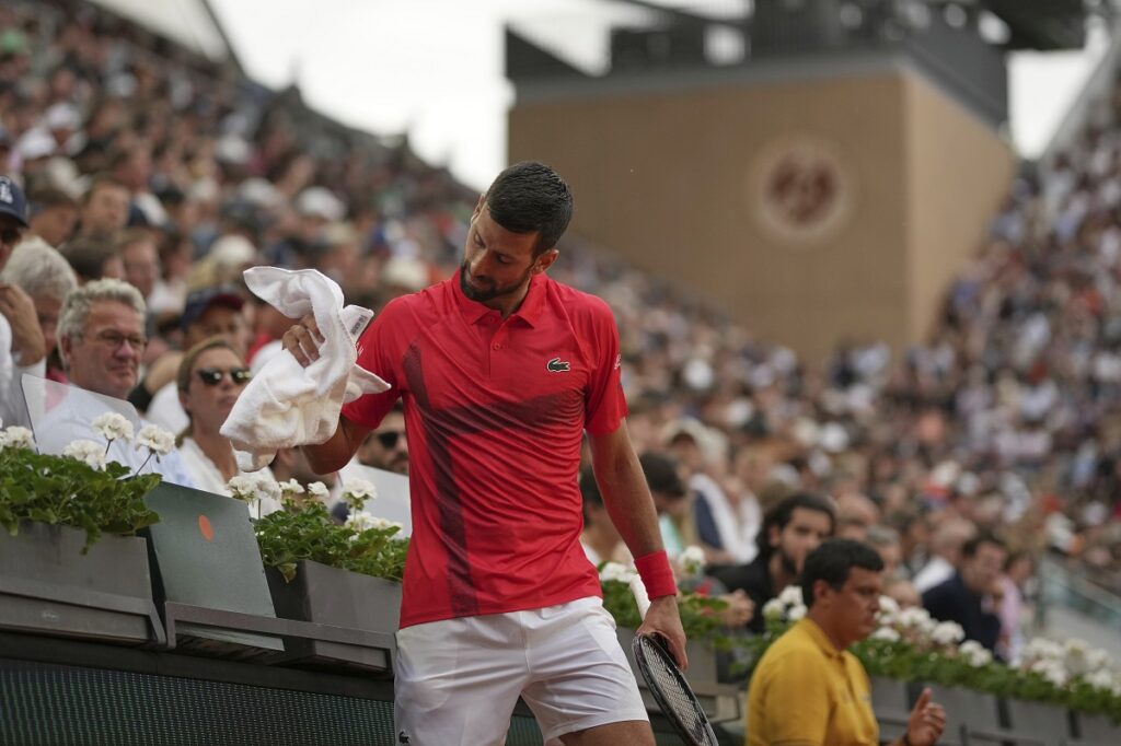 Serbia's Novak Djokovic holds a towel as he plays France's Corentin Moutet during their second round match of the French Tennis Open, at the Roland-Garros stadium, in Paris, Thursday, May 29, 2025. (AP Photo/Christophe Ena)
