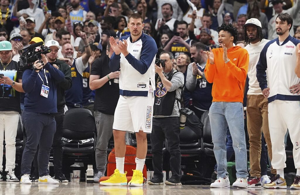 Denver Nuggets center Nikola Jokic applauds as time winds down in the second half of Game 5 of an NBA basketball playoff series against the Los Angeles Clippers, Tuesday, April 29, 2025, in Denver. (AP Photo/David Zalubowski)