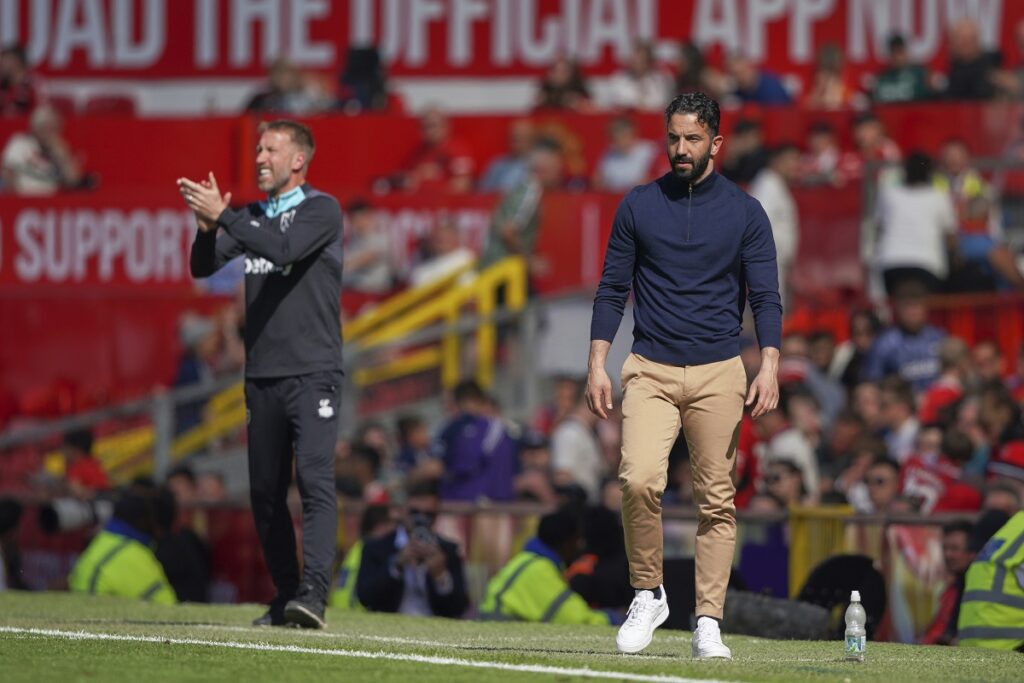 Manchester United's head coach Ruben Amorim, right, and West Ham's head coach Graham Potter react during the English Premier League soccer match between Manchester United and West Ham at Old Trafford stadium in Manchester, England, Sunday, May 11, 2025. (AP Photo/Ian Hodgson)