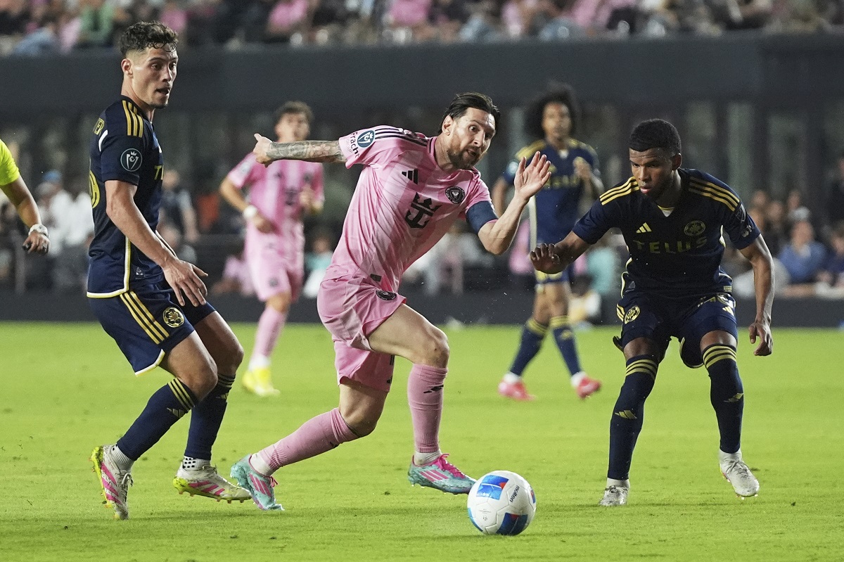 Inter Miami forward Lionel Messi, center, controls the ball during the second half of a CONCACAF Champions Cup second-leg semifinal soccer match against the Vancouver Whitecaps, Wednesday, April 30, 2025, in Fort Lauderdale, Fla. (AP Photo/Lynne Sladky)