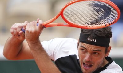 Taylor Fritz of the U.S. returns the ball to Germany's Daniel Altmaier during their first round match of the French Tennis Open, at the Roland-Garros stadium, in Paris, Monday, May 26, 2025. (AP Photo/Lindsey Wasson)