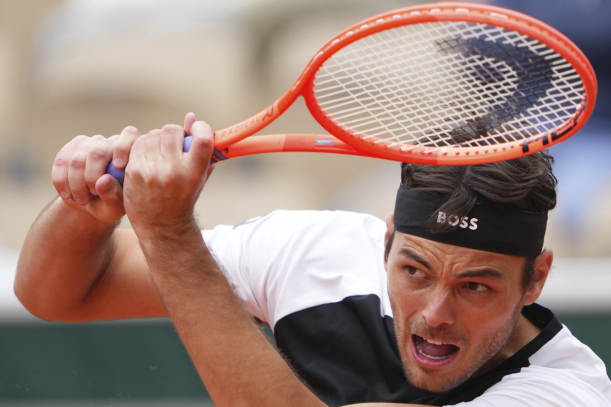 Taylor Fritz of the U.S. returns the ball to Germany's Daniel Altmaier during their first round match of the French Tennis Open, at the Roland-Garros stadium, in Paris, Monday, May 26, 2025. (AP Photo/Lindsey Wasson)