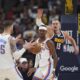 Oklahoma City Thunder center Isaiah Hartenstein (55) fields a pass from guard Shai Gilgeous-Alexander (2) as Denver Nuggets center Nikola Jokic, right, defends in the first half of Game 4 in the Western Conference semifinals of the NBA basketball playoffs Sunday, May 11, 2025, in Denver. (AP Photo/David Zalubowski)