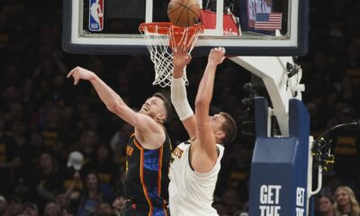Oklahoma City Thunder's Isaiah Hartenstein, left, and Denver Nuggets' Nikola Jokic, right, compete for a rebound in the first half of Game 2 in the conference semifinals of the NBA basketball playoffs, Wednesday, May 7, 2025, in Oklahoma City. (AP Photo/Kyle Phillips)