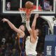 Oklahoma City Thunder's Isaiah Hartenstein, left, and Denver Nuggets' Nikola Jokic, right, compete for a rebound in the first half of Game 2 in the conference semifinals of the NBA basketball playoffs, Wednesday, May 7, 2025, in Oklahoma City. (AP Photo/Kyle Phillips)
