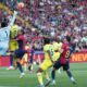 Barcelona's Raphinha, third from left, and Robert Lewandowski, right, challenge for the ball with Villarreal's goalkeeper Luiz Junior, left, Juan Foyth, second from left, and Willy Kambwala during the Spanish La Liga soccer match between Barcelona and Villarreal at Lluis Companys Olympic Stadium in Barcelona, Spain, Sunday, May 18, 2025. (AP Photo/Joan Monfort)