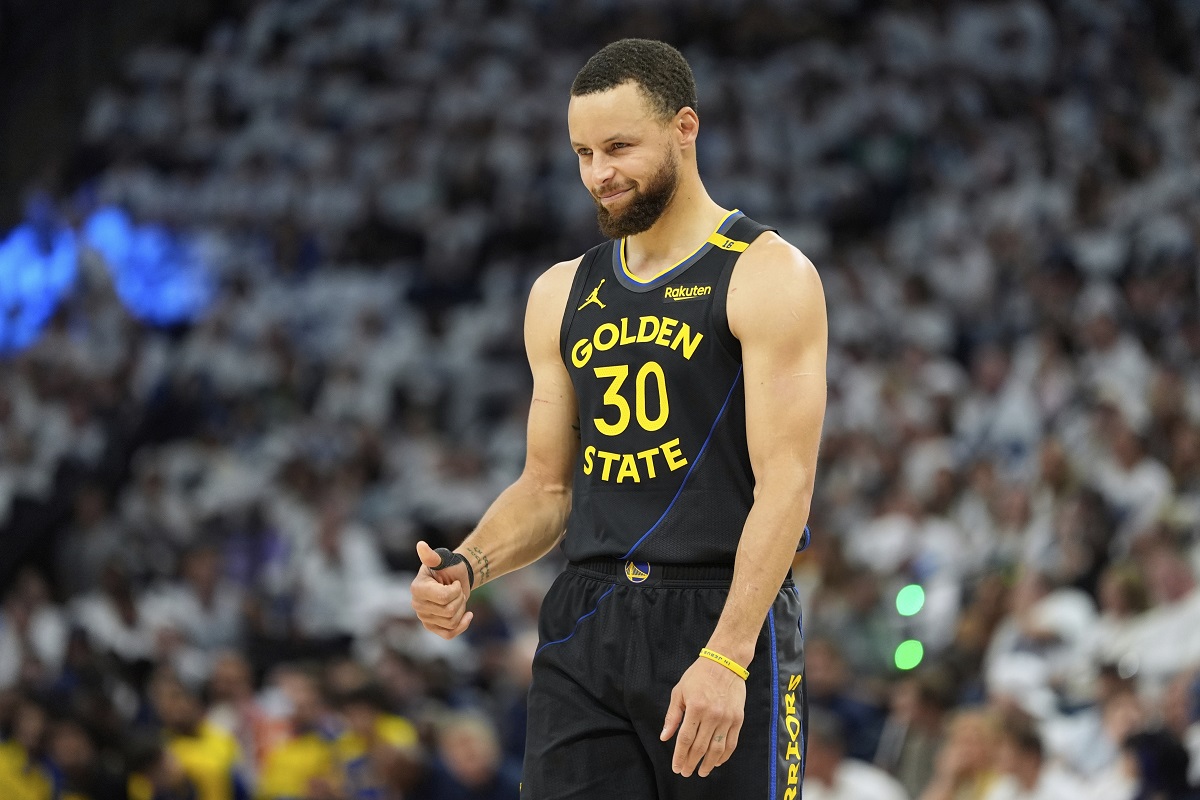 Golden State Warriors guard Stephen Curry (30) gestures during the first half of Game 1 of an NBA basketball second-round playoff series against the Minnesota Timberwolves, Tuesday, May 6, 2025, in Minneapolis. (AP Photo/Abbie Parr)