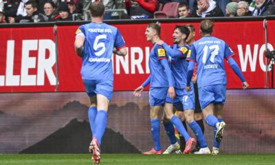 Kiel's Ivan Nekic, second left, celebrates with his teammates after scoring against Augsburg during the German Bundesliga soccer match between FC Augsburg and Holstein Kiel at the WWK-Arena in Augsburg, Germany, Sunday, May 4, 2025. (Armin Weigel/dpa via AP)
