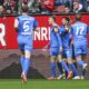 Kiel's Ivan Nekic, second left, celebrates with his teammates after scoring against Augsburg during the German Bundesliga soccer match between FC Augsburg and Holstein Kiel at the WWK-Arena in Augsburg, Germany, Sunday, May 4, 2025. (Armin Weigel/dpa via AP)
