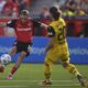 Leverkusen's Florian Wirtz, left, plays the ball during the German Bundesliga soccer match between Bayer 04 Leverkusen and Borussia Dortmund in Leverkusen, Germany, Sunday, May 11, 2025. (Marius Becker/dpa via AP)