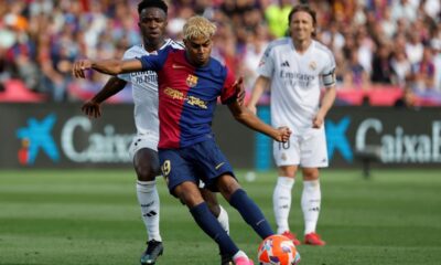 Barcelona's Lamine Yamal shoots in front of Real Madrid's Vinicius Junior during the La Liga soccer match between Barcelona and Real Madrid in Barcelona, Spain, Sunday, May 11, 2025. AP Photo/Joan Monfort)
