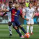 Barcelona's Lamine Yamal shoots in front of Real Madrid's Vinicius Junior during the La Liga soccer match between Barcelona and Real Madrid in Barcelona, Spain, Sunday, May 11, 2025. AP Photo/Joan Monfort)