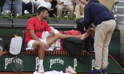 Serbia's Novak Djokovic receives medical assistance during his second round match of the French Tennis Open against France's Corentin Moutet, at the Roland-Garros stadium, in Paris, Thursday, May 29, 2025. (AP Photo/Christophe Ena)