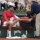 Serbia's Novak Djokovic receives medical assistance during his second round match of the French Tennis Open against France's Corentin Moutet, at the Roland-Garros stadium, in Paris, Thursday, May 29, 2025. (AP Photo/Christophe Ena)