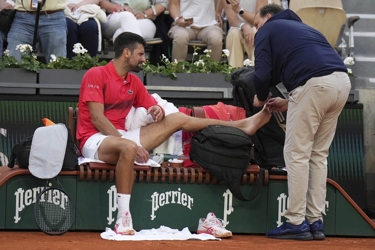 Serbia's Novak Djokovic receives medical assistance during his second round match of the French Tennis Open against France's Corentin Moutet, at the Roland-Garros stadium, in Paris, Thursday, May 29, 2025. (AP Photo/Christophe Ena)