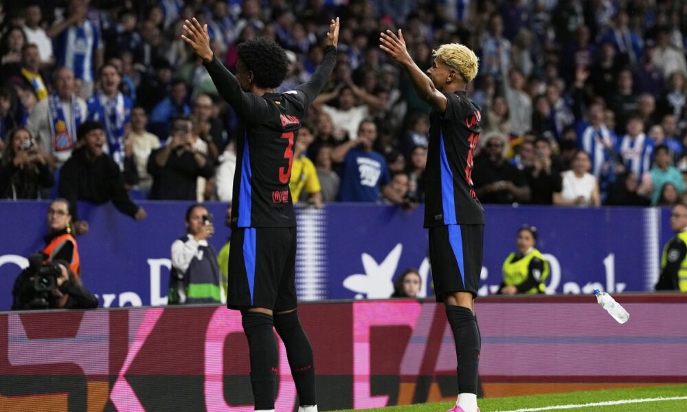 Barcelona's Alejandro Balde, left, and Lamine Yamal celevrate after a goal during a Spanish La Liga soccer match between Espanyol and Barcelona in Barcelona, Spain, Thursday, May 15, 2025. (AP Photo/Jose Breton)