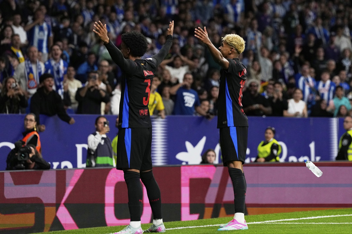 Barcelona's Alejandro Balde, left, and Lamine Yamal celevrate after a goal during a Spanish La Liga soccer match between Espanyol and Barcelona in Barcelona, Spain, Thursday, May 15, 2025. (AP Photo/Jose Breton)