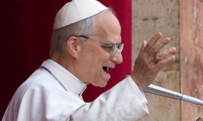 FILE- Pope Leo XIV speaks from the central balcony of St. Peter's Basilica on Sunday, May 11, 2025. (AP Photo/Domenico Stinellis, File)