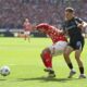 Mainz's Stefan Bell, left and Leverkusen's Florian Wirtz vie for the ball., during the German Bundesliga soccer match between 1. FSV Mainz 05 and Bayer Leverkusen, at the Mewa Arena, in Mainz, Germany, Saturday, May 17, 2025. (Arne Deder/dpa via AP)