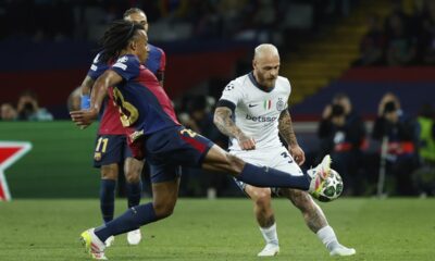 Barcelona's Jules Kounde, left, fights for the ball with Inter Milan's Federico Dimarco during the Champions League semifinal first leg soccer match between Barcelona and Inter Milan at the Lluis Companys Olympic Stadium in Barcelona, Spain, Wednesday, April 30, 2025. (AP Photo/Joan Monfort)