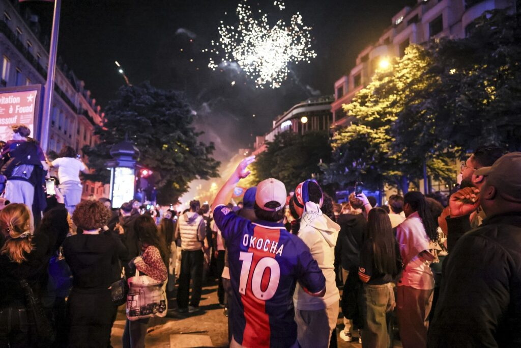 Paris Saint-Germain fans celebrate after the Champions League semifinal, second leg soccer match between PSG and Arsenal on the Champs-Elysees avenue in Paris, Wednesday, May 7, 2025. (AP Photo/Thomas Padilla)