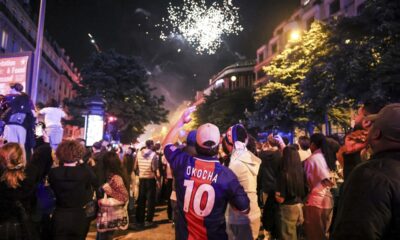 Paris Saint-Germain fans celebrate after the Champions League semifinal, second leg soccer match between PSG and Arsenal on the Champs-Elysees avenue in Paris, Wednesday, May 7, 2025. (AP Photo/Thomas Padilla)