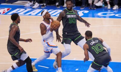 Oklahoma City Thunder guard Shai Gilgeous-Alexander, center, drives to the basket against Minnesota Timberwolves guard Anthony Edwards, left, forward Julius Randle (30) and guard Mike Conley (10) during the first half of Game 1 of an NBA basketball Western Conference Finals playoff series Tuesday, May 20, 2025, in Oklahoma City. (AP Photo/Nate Billings)