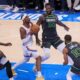 Oklahoma City Thunder guard Shai Gilgeous-Alexander, center, drives to the basket against Minnesota Timberwolves guard Anthony Edwards, left, forward Julius Randle (30) and guard Mike Conley (10) during the first half of Game 1 of an NBA basketball Western Conference Finals playoff series Tuesday, May 20, 2025, in Oklahoma City. (AP Photo/Nate Billings)