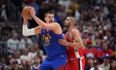 Denver Nuggets center Nikola Jokic, left, looks to pass the ball as Los Angeles Clippers forward Nicolas Batum, right, defends in the second half of Game 7 of an NBA basketball first-round playoff series Saturday, May 3, 2025, in Denver. (AP Photo/David Zalubowski)