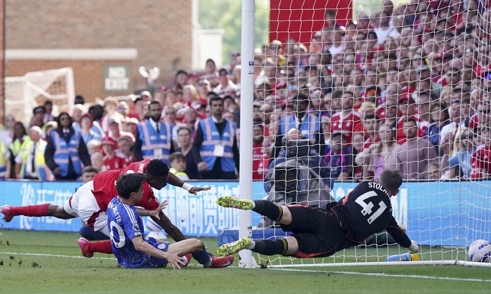 Nottingham Forest's Taiwo Awoniyi, left, and Leicester City's Facundo Buonanotte collide with the goal post during a Premier League soccer match at City Ground in Nottingham, England, Sunday May 11, 2025. (Jacob King/PA via AP)