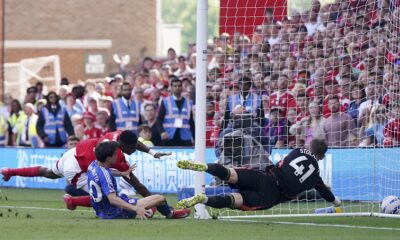 Nottingham Forest's Taiwo Awoniyi, left, and Leicester City's Facundo Buonanotte collide with the goal post during a Premier League soccer match at City Ground in Nottingham, England, Sunday May 11, 2025. (Jacob King/PA via AP)
