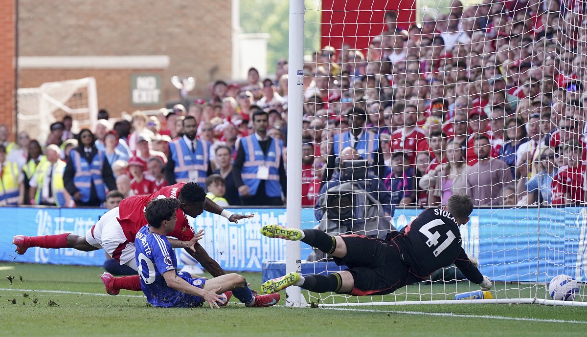 Nottingham Forest's Taiwo Awoniyi, left, and Leicester City's Facundo Buonanotte collide with the goal post during a Premier League soccer match at City Ground in Nottingham, England, Sunday May 11, 2025. (Jacob King/PA via AP)
