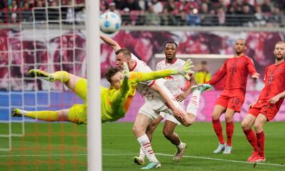 Leipzig's Lukas Klostermann, background left, scores his side's second goal past Bayern's goalkeeper Jonas Urbig during the German Bundesliga soccer match between RB Leipzig and FC Bayern Munich at the Red Bull Arena in Leipzig, Germany, Saturday, May 3, 2025. (AP Photo/Matthias Schrader)