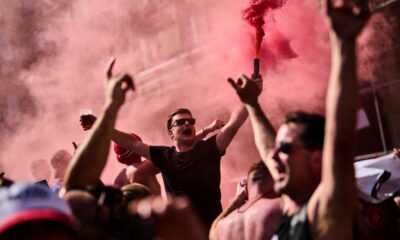 Manchester United fans cheer while gathering in downtown Bilbao, Spain, ahead of the UEFA Europa League final soccer match between Manchester United and Tottenham Hotspur, Tuesday, May 20, 2025. (AP Photo/Bernat Armangue)