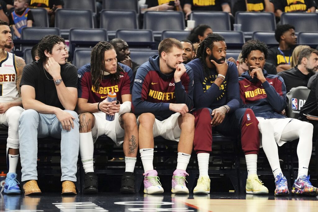 Denver Nuggets' Nikola Jokic, center, and the rest of the bench watch play against the Oklahoma City Thunder late in the second half of Game 2 in the conference semifinals of the NBA basketball playoffs, Wednesday, May 7, 2025, in Oklahoma City. (AP Photo/Kyle Phillips)
