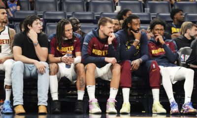 Denver Nuggets' Nikola Jokic, center, and the rest of the bench watch play against the Oklahoma City Thunder late in the second half of Game 2 in the conference semifinals of the NBA basketball playoffs, Wednesday, May 7, 2025, in Oklahoma City. (AP Photo/Kyle Phillips)