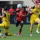Dortmund's Daniel Svensson, right, and Leverkusen's Jeremie Frimpong, second right, challenge for the ball during the German Bundesliga soccer match between Bayer 04 Leverkusen and Borussia Dortmund in Leverkusen, Germany, Sunday, May 11, 2025. (Rolf Vennenbernd/dpa via AP)