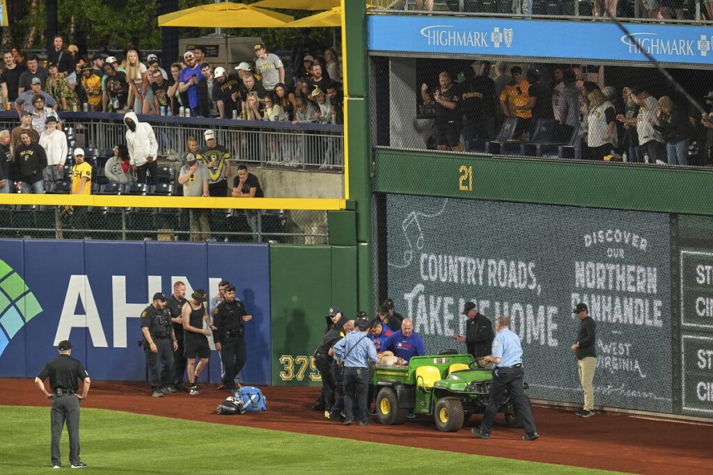A fan is carted off the field at PNC Park after falling out of the stands during the seventh inning of a baseball game between the Pittsburgh Pirates and the Chicago Cubs in Pittsburgh, Wednesday, April 30, 2025. (AP Photo/Gene J. Puskar)